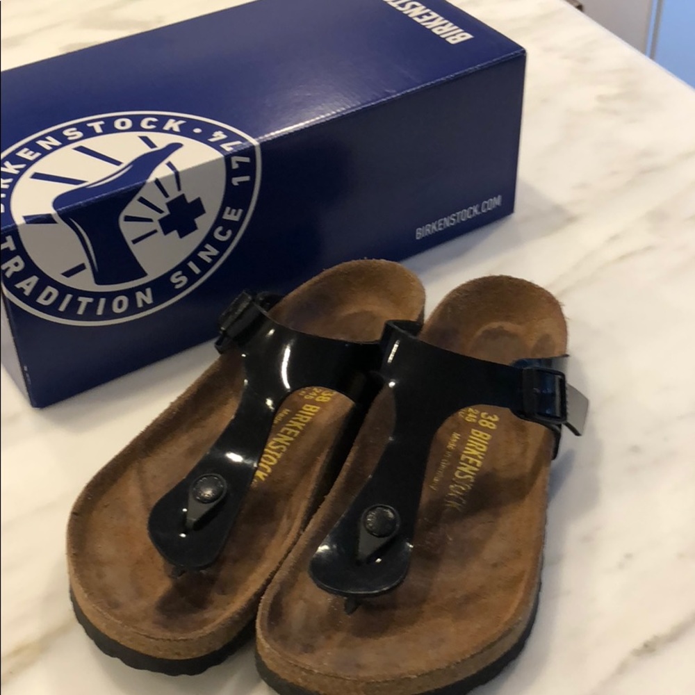 Birkenstock Gizeh black patent leather sandals.